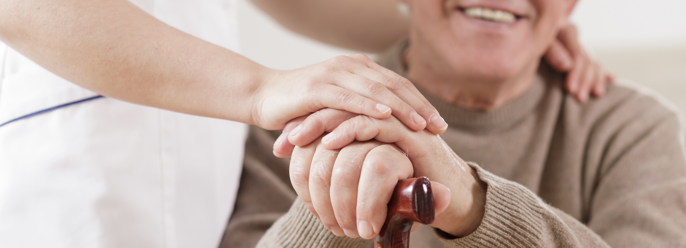 Smiling disabled senior man and caring nurse